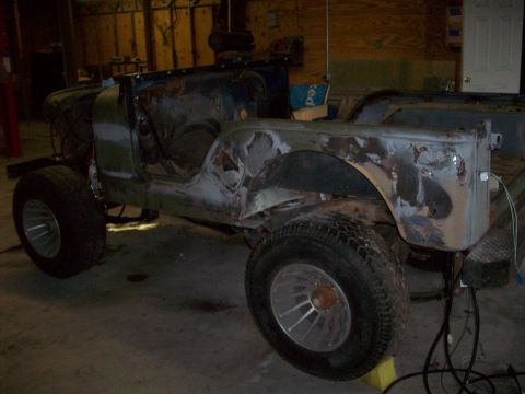 1978 Jeep CJ5 - This 1978 Jeep CJ5 is in a workshop, likely undergoing restoration work.
