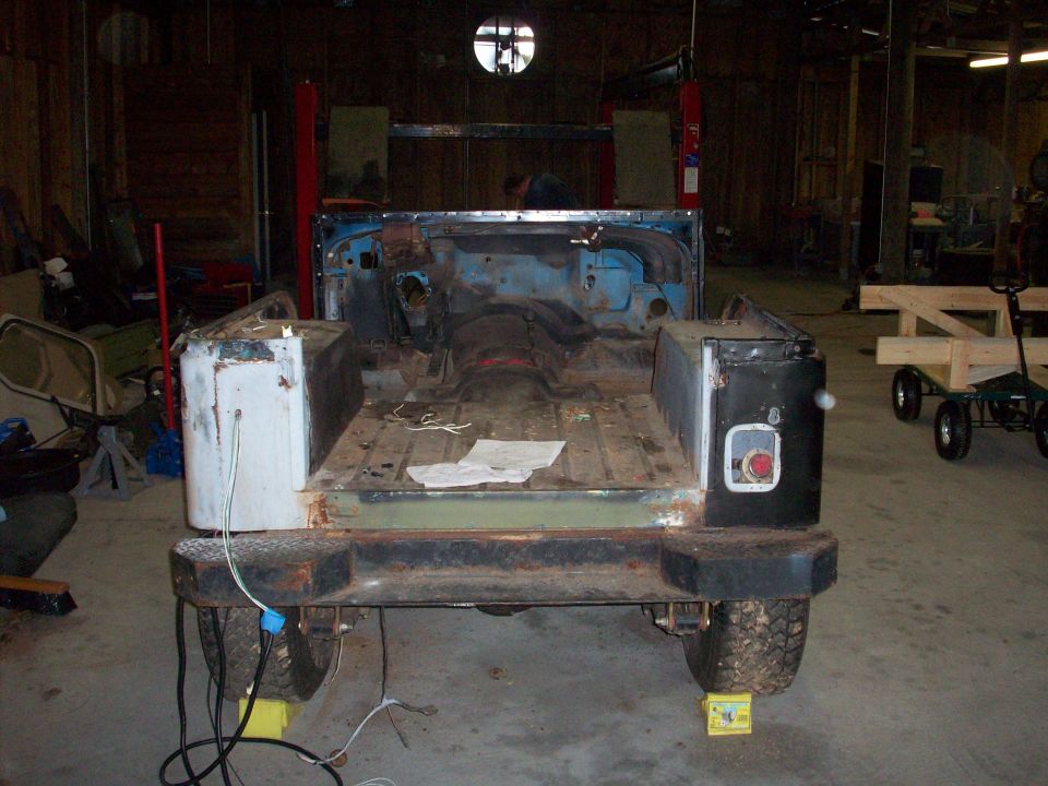 Back of a Jeep CJ body, stripped down and in a workshop. It's missing doors and a top