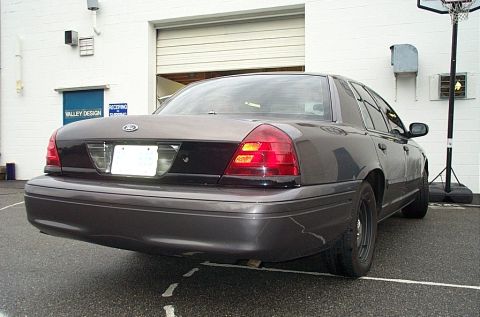 2001 Ford Crown Victoria - The rear of a 2001 Ford Crown Victoria sedan is shown in a parking lot.