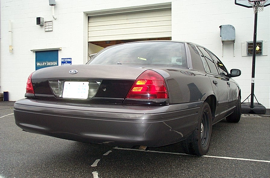 Rear view of a 2001 Ford Crown Victoria sedan, dark gray