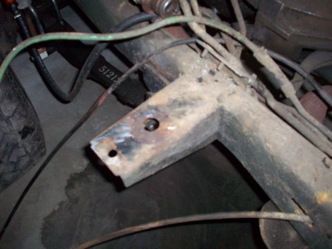 1978 Jeep CJ5 - Close-up of a rusted vehicle frame section, showing wiring and a partial tire. A part number is visible.