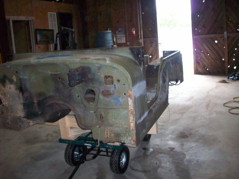 1978 Jeep CJ5 - The body of a 1978 Jeep CJ5 is shown on a dolly in a barn, awaiting restoration.