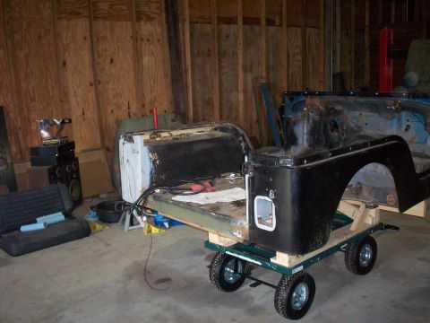 1978 Jeep CJ5 - The body of a 1978 Jeep CJ5 is shown disassembled and mounted on a dolly for transport.