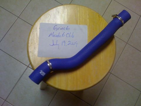 1994 Ford Probe - A blue silicone hose with metal clamps is displayed on a wooden surface next to a note dated July 19, 2009.