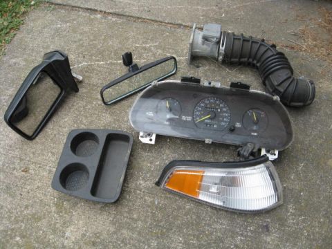 1996 Mercury Grand Marquis - random escort parts. mass air flow sensor and air tube. mirror. side mirror. dash cluster. turn signal assembly.