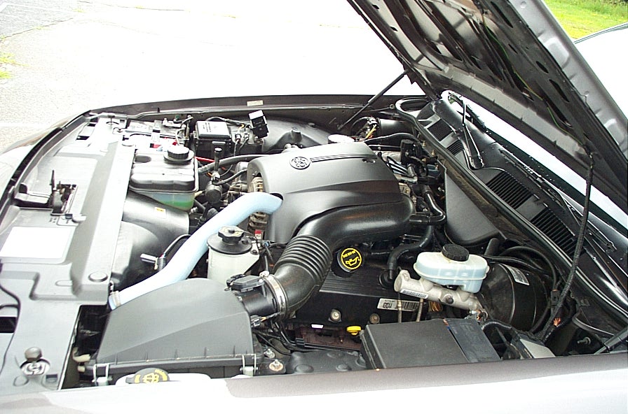 Engine bay with V8 engine cover and air intake