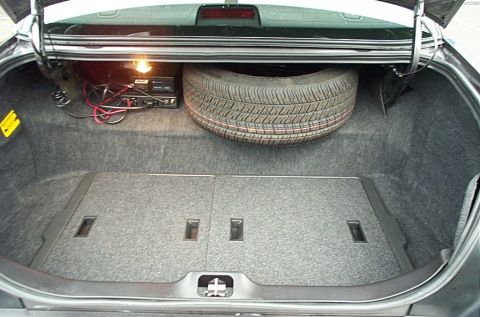2001 Ford Crown Victoria - The trunk of a 2001 Ford Crown Victoria contains a spare tire and aftermarket electronic equipment.