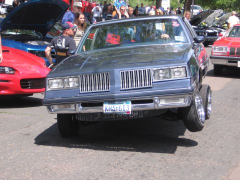 2001 Chevrolet Silverado 1500 - Customized 1980s Oldsmobile Cutlass Supreme on display with other vehicles.