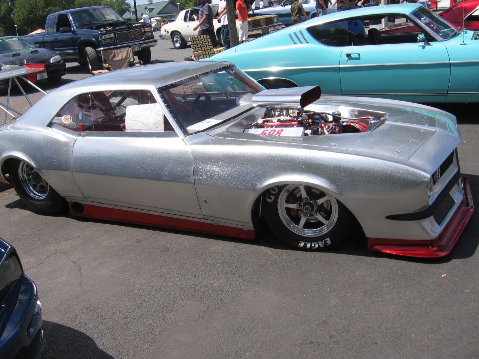 Silver customized classic car with exposed engine and red trim