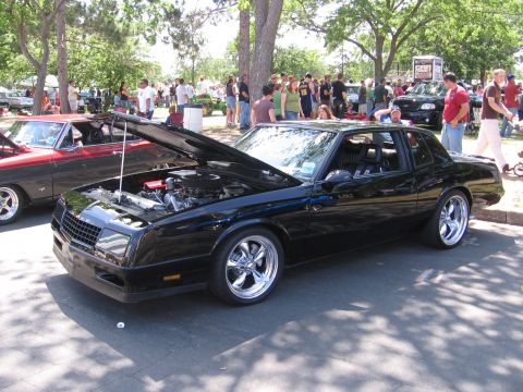 2001 Chevrolet Silverado 1500 - Black coupe with hood open at a car show, chrome wheels visible.