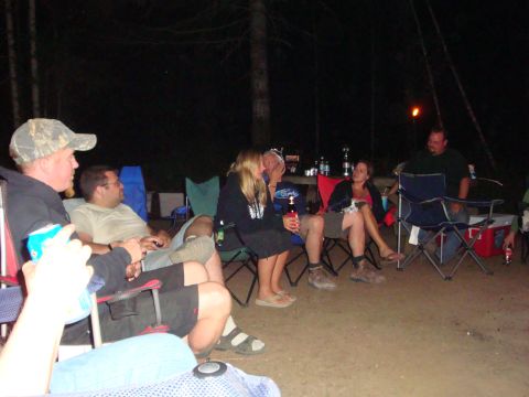 1978 Ford Bronco - People gathered around a campfire at night, enjoying drinks and conversation.