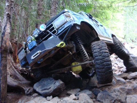 1978 Ford Bronco - This modified SUV is shown off-roading on a challenging rocky trail.