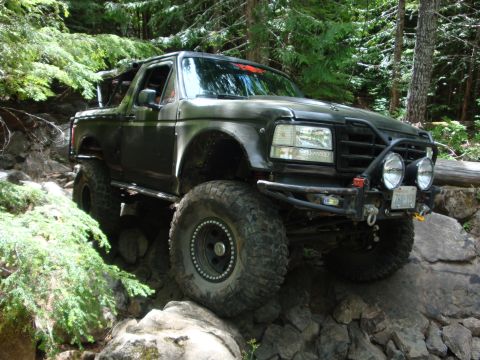 1978 Ford Bronco - This modified 1992 Ford Bronco navigates a challenging rocky trail, demonstrating its off-road capabilities.
