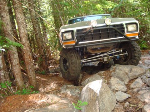 1978 Ford Bronco - This modified 1978 Ford Bronco tackles a challenging rocky path through a wooded area.