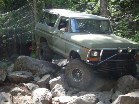 1978 Ford Bronco - This 1978 Ford Bronco navigates a challenging rocky terrain in a forest setting.