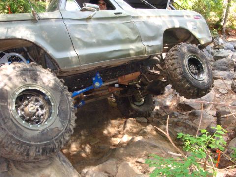 1978 Ford Bronco - This heavily modified 1978 Ford Bronco tackles a challenging rock crawling course with its oversized tires and lifted suspension.