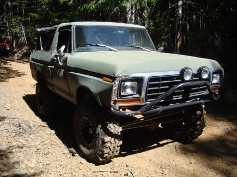 1978 Ford Bronco - This lifted 1978 Ford Bronco, painted olive green, is equipped with off-road tires and a custom brush guard, ready for adventure.