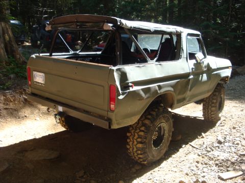 1978 Ford Bronco - Rear view of a 1978 Ford Bronco with its soft top removed, parked off-road.
