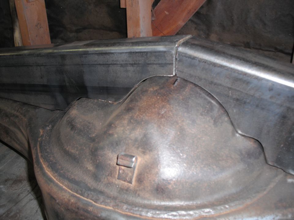 Close-up of bare rusty axle housing center section on a shop bench
