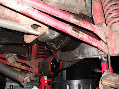 1991 Ford Bronco - Undercarriage view of a 1991 Ford Bronco, focusing on the suspension and differential during maintenance.