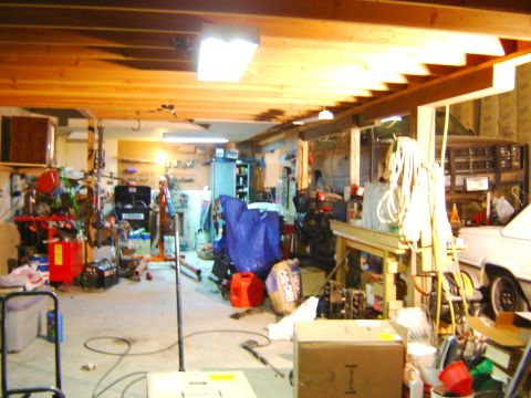 1984 Ford Mustang - A cluttered garage scene shows a white car partially visible on the right side.