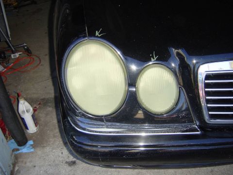 1995 Ford Taurus - Front view of a black Mercedes-Benz E-Class, likely a 1996 model, with green markings on the hood.