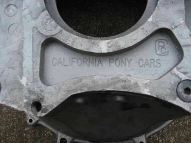 Close-up of an engine part with 'CALIFORNIA PONY CARS' and 'ONTARIO, CA' stamped on it