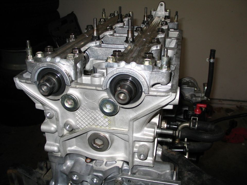 Aluminum DOHC four-cylinder head with camshafts and cam gear snouts exposed