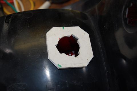 1985 Mercury Grand Marquis - A close-up view of a modified tail light housing, showing a template for a new bulb socket.