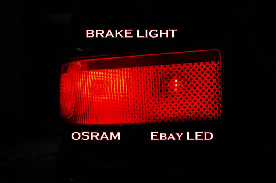 Lit tail light comparing a bright Osram brake bulb against a dim eBay LED bulb