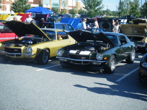 1991 Nissan Micra - Two vintage cars are parked side-by-side with their hoods raised at an outdoor event.