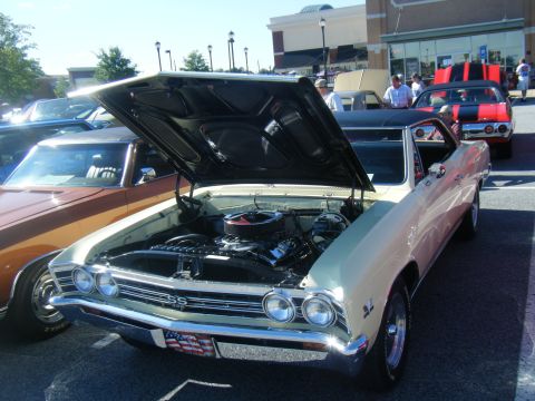 1991 Nissan Micra - A cream 1967 Chevrolet Chevelle SS is displayed with its hood open, revealing the engine bay.