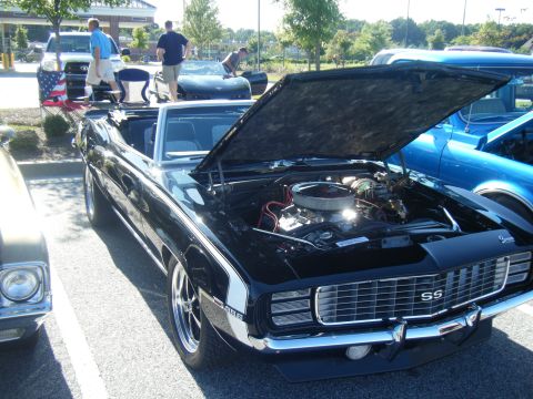 1991 Nissan Micra - Black 1969 Camaro SS convertible shows off its engine at a car show.