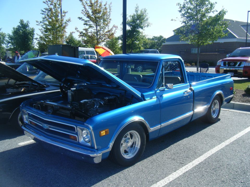 Blue 1971 pickup truck, 3q-front view, hood open. Text reads SUPERMOTORS