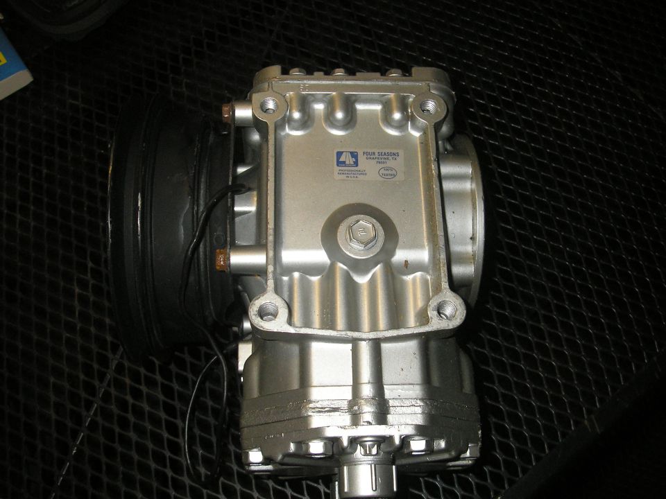 Four Seasons air conditioning compressor with label showing "FOUR SEASONS" and "SHERMAN, TX"