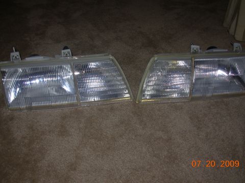 1995 Ford Taurus - Pair of car headlights shown on a carpeted floor. Date stamp indicates 07.20.2009.