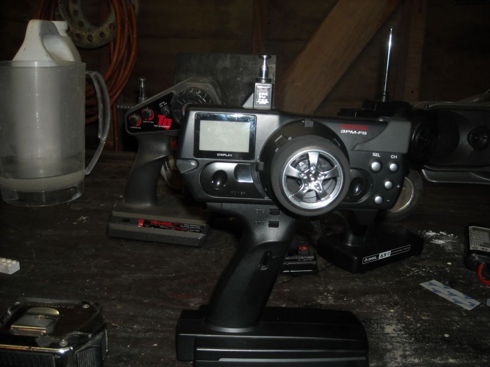 3PM-FS RC pistol-grip transmitter on a workbench in a dim garage