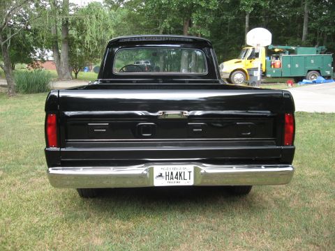 1966 Ford F-100 - This black 1966 Ford F-100 pickup truck is viewed from the rear, showing its classic body style and a Georgia license plate.