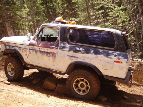 1978 Ford Bronco - This 1978 Ford Bronco is shown navigating a challenging off-road trail with its tires and lifted suspension.