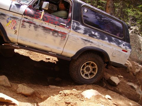 1978 Ford Bronco - This 1978 Ford Bronco is navigating a challenging off-road trail with steep inclines and rocks.