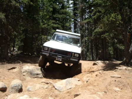 1978 Ford Bronco - White 1978 Ford Bronco tackling a challenging rocky trail.