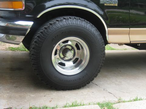 1994 Ford Bronco - Close-up of a Ford Bronco's front wheel and fender, showing the 'All-Terrain T/A' tires.