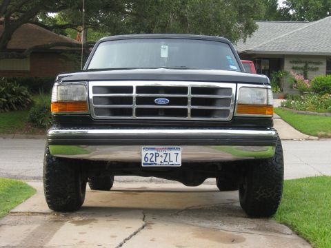 1994 Ford Bronco - Front view of a black Ford Bronco with a chrome grille and large tires.