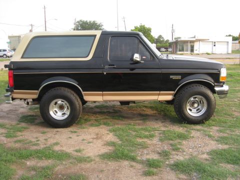 1994 Ford Bronco - This 1994 Ford Bronco is shown from the side, parked outdoors on a grassy area.