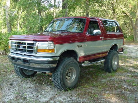 1996 Ford Bronco - Two-tone red and silver 1996 Ford Bronco with lifted suspension.
