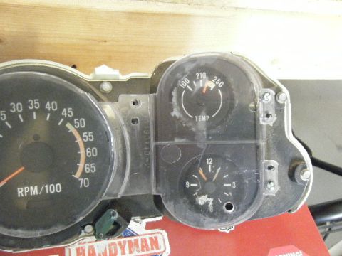 1991 Nissan Micra - Close-up of a vehicle's dashboard gauges, including RPM, temperature, and clock indicators.