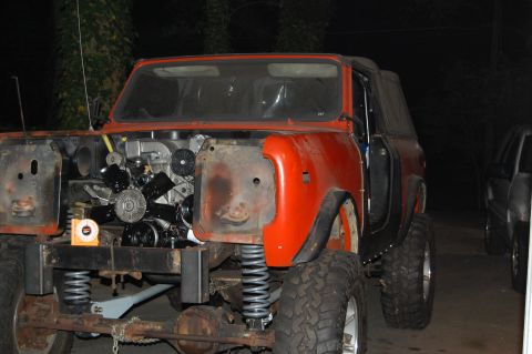 1994 Ford Bronco - This orange SUV is missing its front clip, revealing the engine and suspension components.