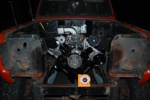 1994 Ford Bronco - Engine bay with a newly installed engine. A yellow inclinometer is visible on the frame.