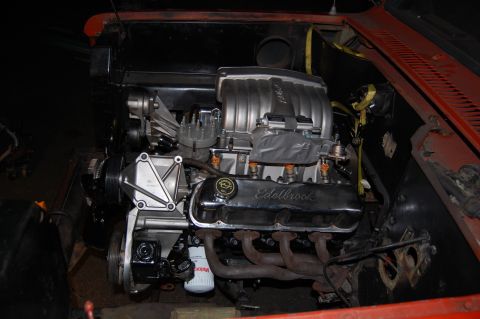1994 Ford Bronco - Close-up view of a V8 engine, Edelbrock valve covers and an aftermarket intake system.
