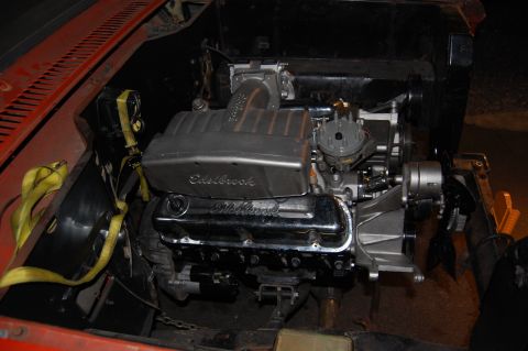 1994 Ford Bronco - Engine compartment with a V8 engine, an Edelbrock intake and chrome valve covers.